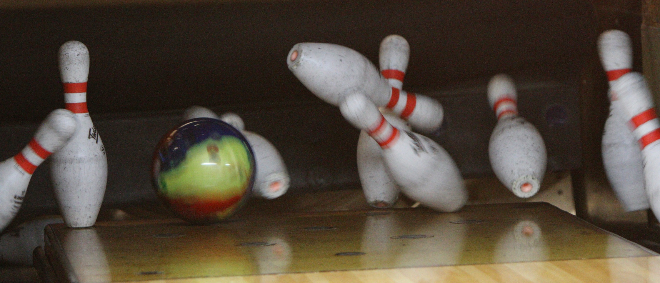 Bowling pins being knocked down