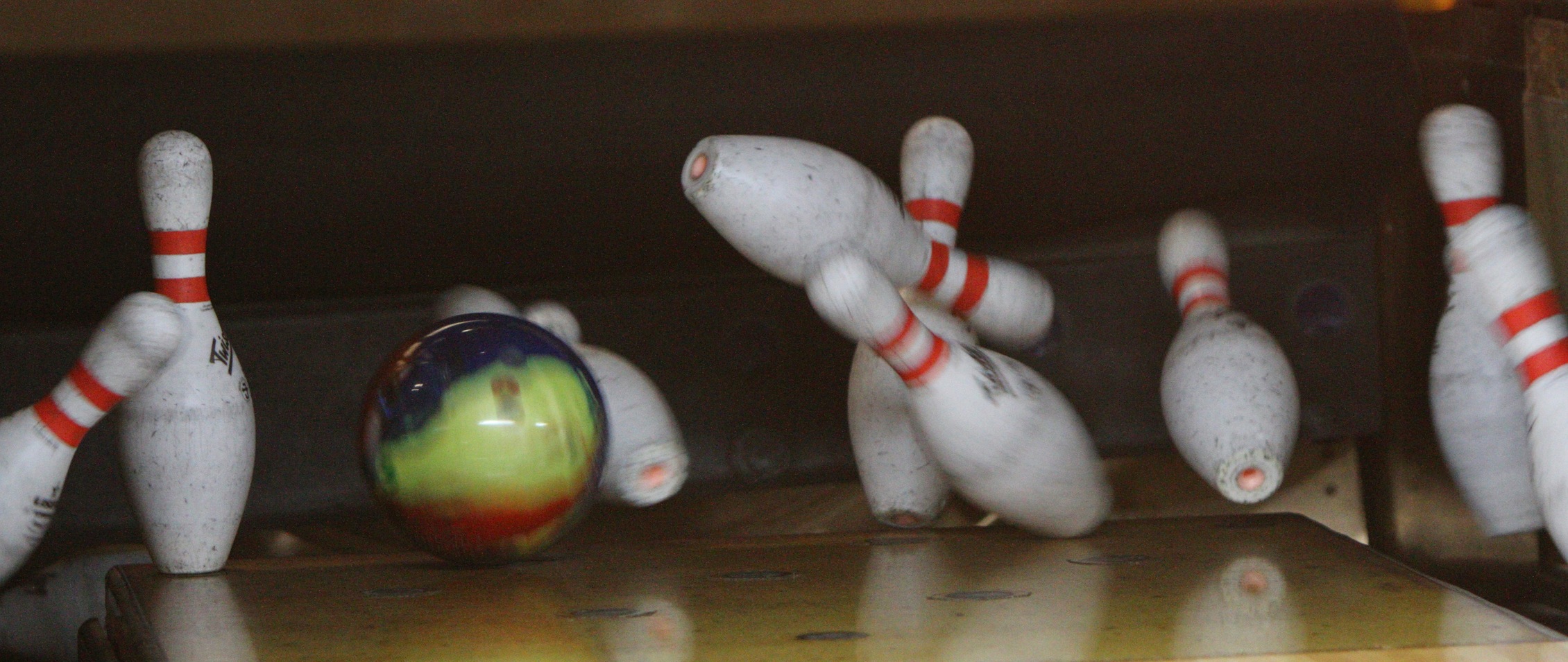 Bowling pins being knocked down